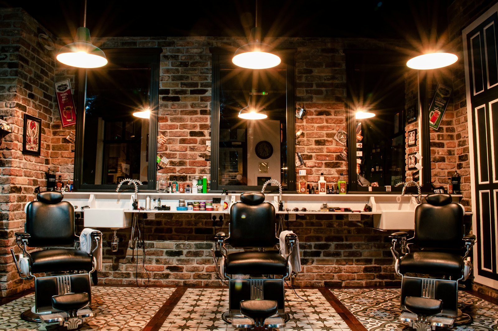 Interior of the barbershop with leather chairs and warm lamps