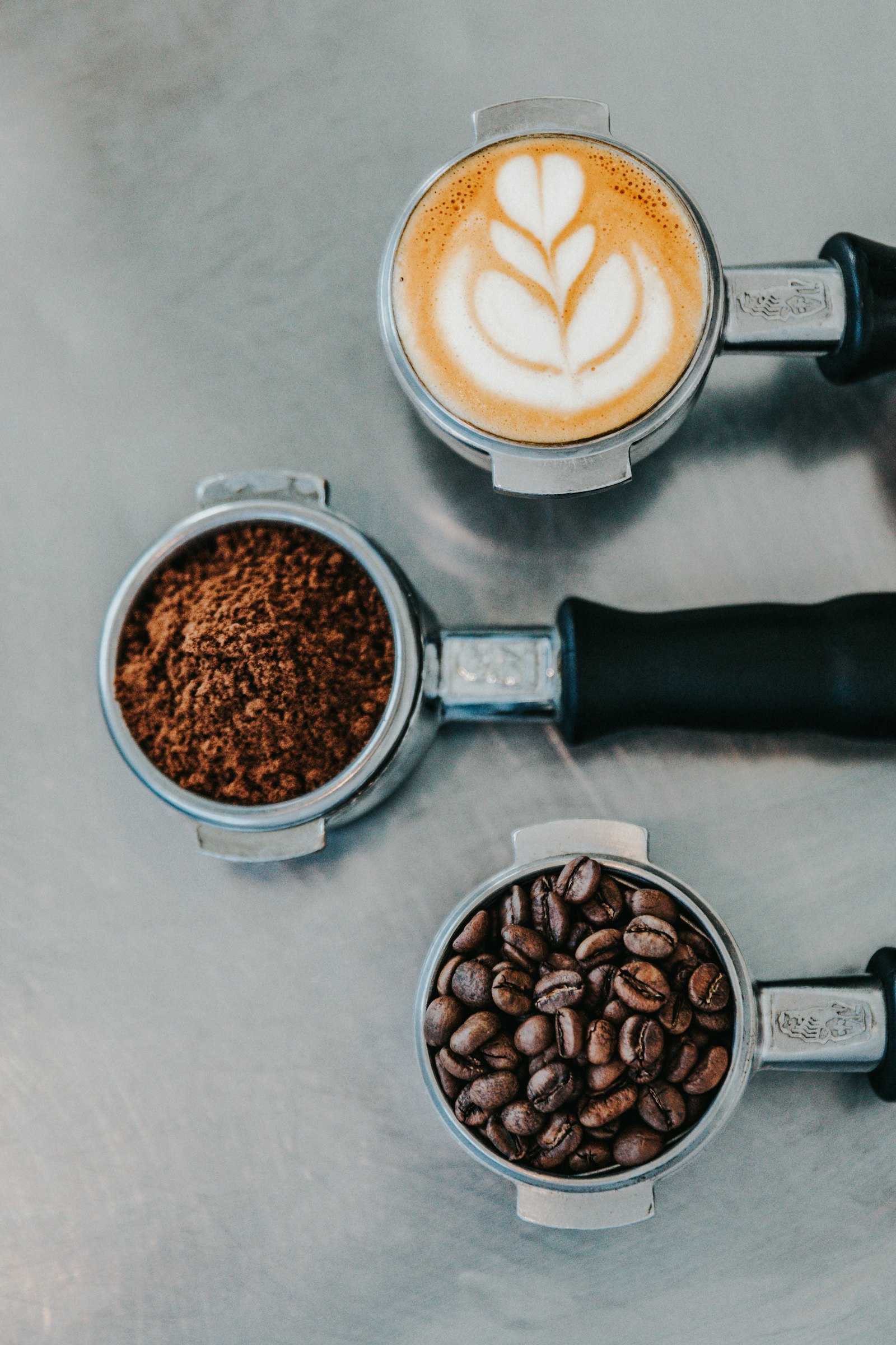 Ground coffee in a portafilter with beans
